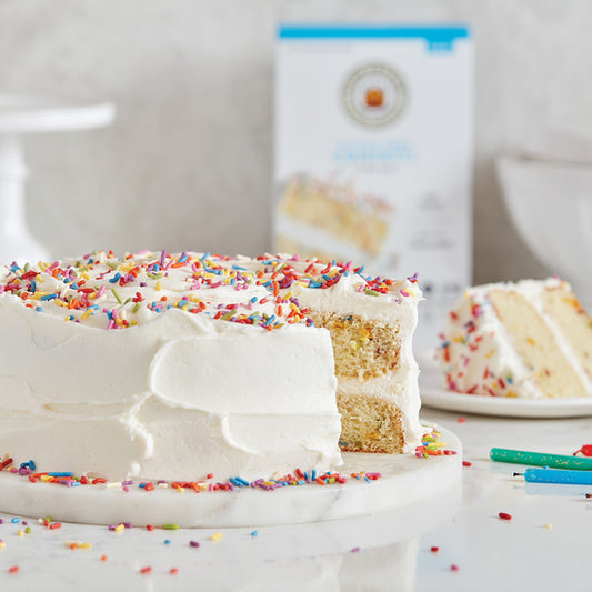 King Arthur Confetti Cake Mix in a box with colorful sprinkles and baking instructions visible on the packaging.