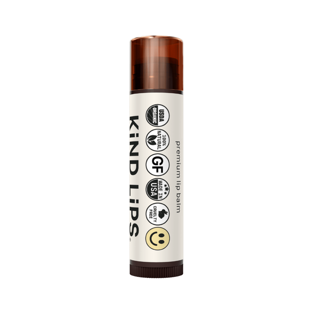 Four tubes of Kind Lips Organic Lip Balm in a variety pack, featuring colorful packaging and natural ingredients for soft, moisturized lips.