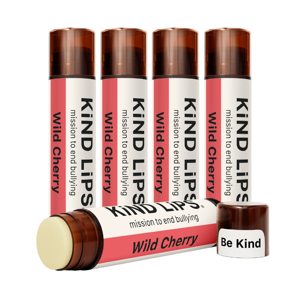Kind Lips Wild Cherry organic lip balm tube with cherry flavor and natural ingredients, displayed against a white background.
