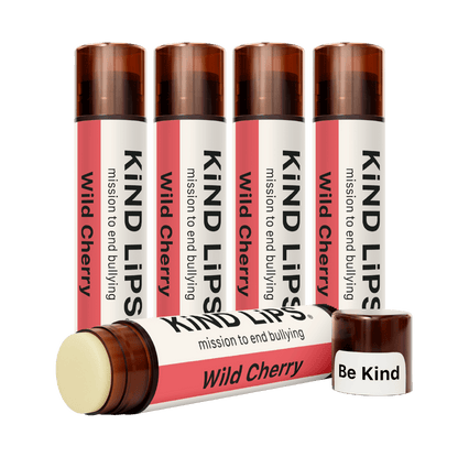 Kind Lips Wild Cherry organic lip balm tube with cherry flavor and natural ingredients, displayed against a white background.