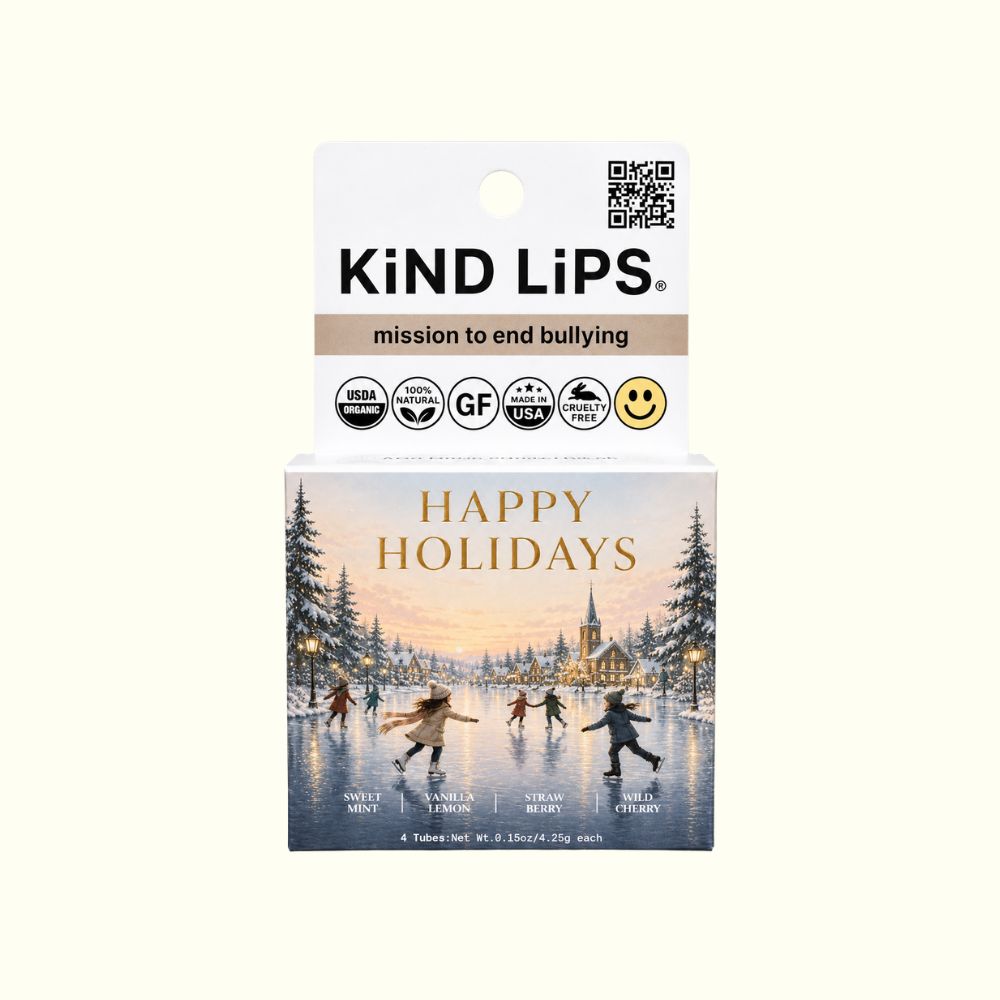 KiND LiPS Happy Holidays lip balm box with a white header card and a winter scene illustration on the front, featuring the text 'HAPPY HOLIDAYS' and flavor labels for Sweet Mint, Vanilla Lemon, Straw Berry, and Wild Cherry.