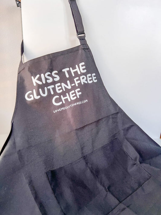 Love Me Gluten Free kitchen apron with adjustable straps and cheerful design, perfect for cooking and baking.