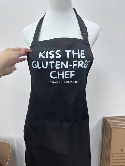 Love Me Gluten Free kitchen apron with kiss design, featuring a durable fabric and adjustable neck strap for cooking and baking.