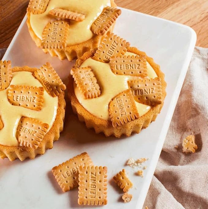 Love Me Gluten Free Leibniz Minis gluten-free dessert cookies on a plate with a fork and glass of milk