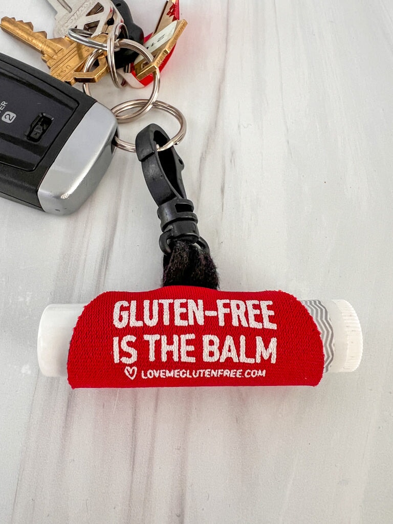 Love Me Gluten Free lip balm holder and keychain with colorful design, compact and portable for easy lip balm access.
