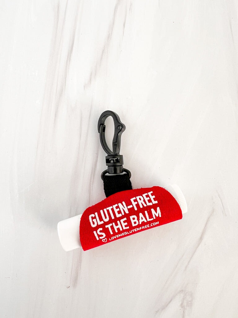 Love Me Gluten Free lip balm holder keychain with colorful silicone design for easy carrying and convenience.