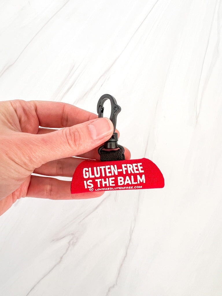 Love Me Gluten Free lip balm holder keychain with colorful silicone design and attached metal keyring for easy carrying.