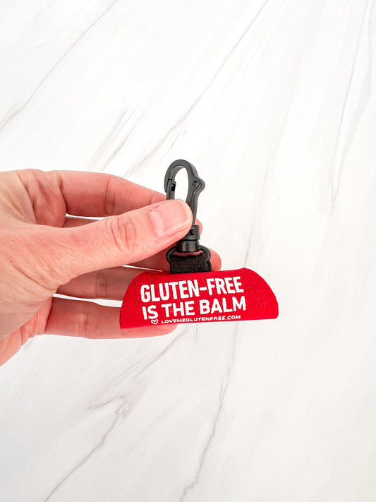 Love Me Gluten Free lip balm holder keychain with colorful silicone design and attached metal keyring for easy carrying.