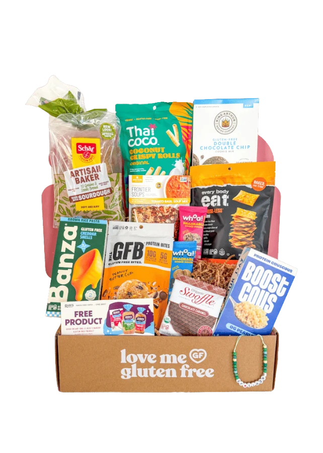 An open Love Me Gluten Free box filled with gluten-free snacks