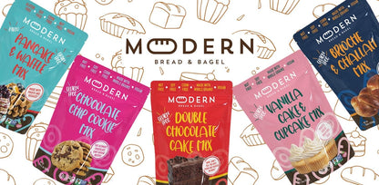 Assorted Modern Bread & Bagel pancake and waffle mixes in colorful packaging, ready for baking.