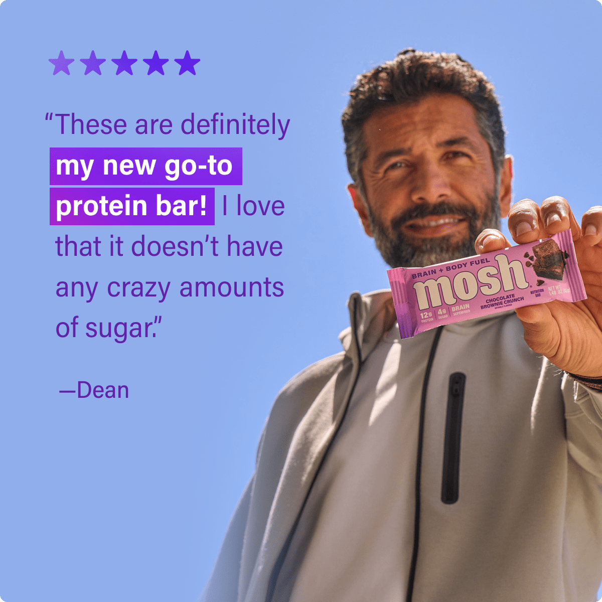 Mosh Chocolate Brownie Crunch protein bar with chocolate and brownie chunks, featuring a textured chocolate coating and crunchy topping.