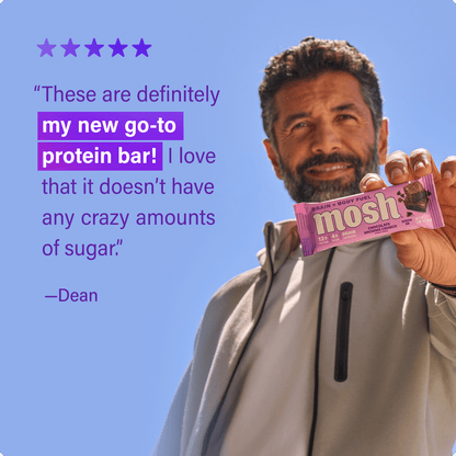 Mosh Chocolate Brownie Crunch protein bar with chocolate and brownie chunks, featuring a textured chocolate coating and crunchy topping.