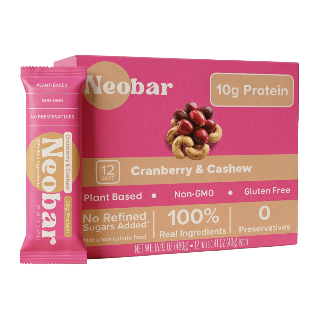 A box of Neobar Cranberry & Cashew protein bars with one individual bar standing in front, shown on a plain white background.