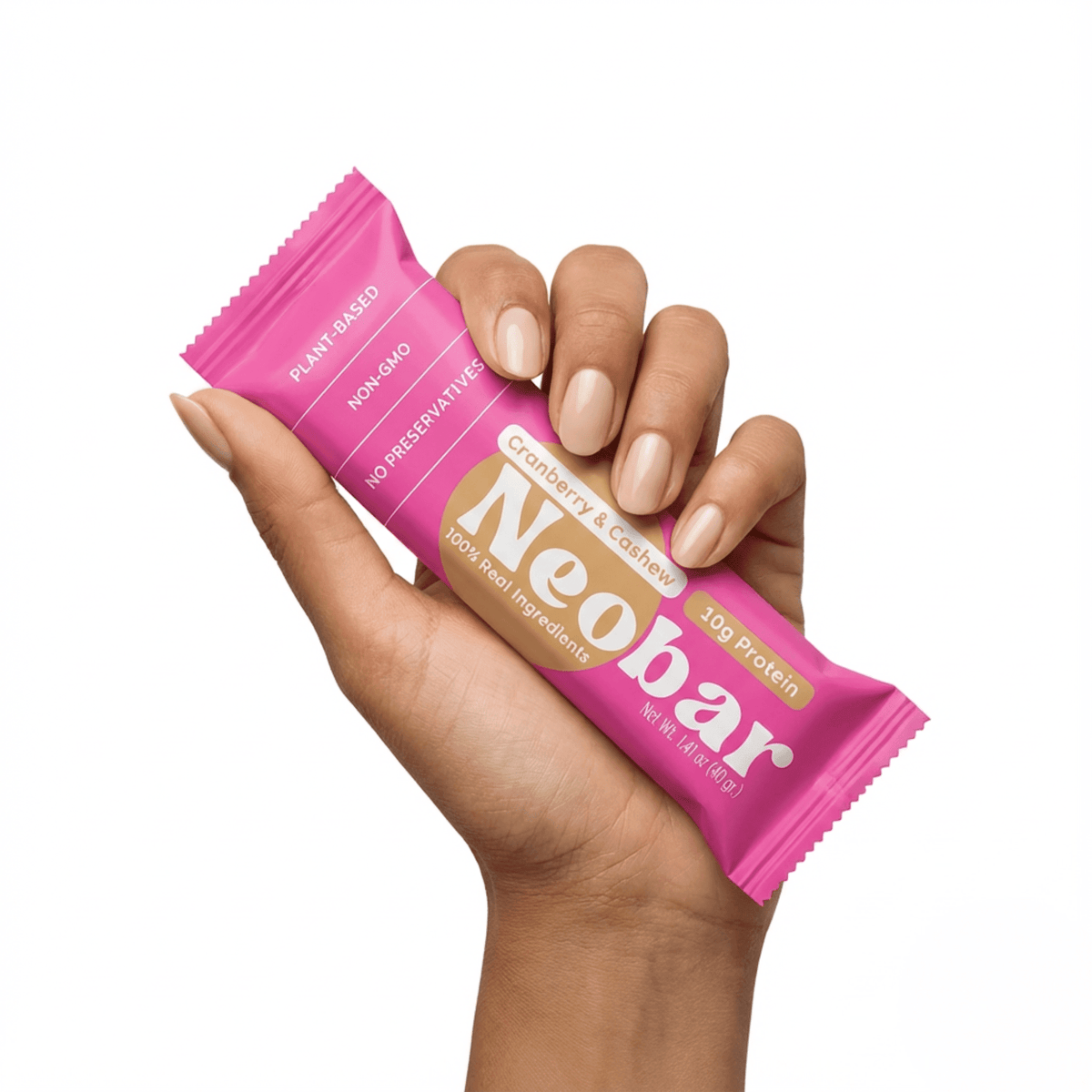Hand holding a pink Neobar protein bar against a white background