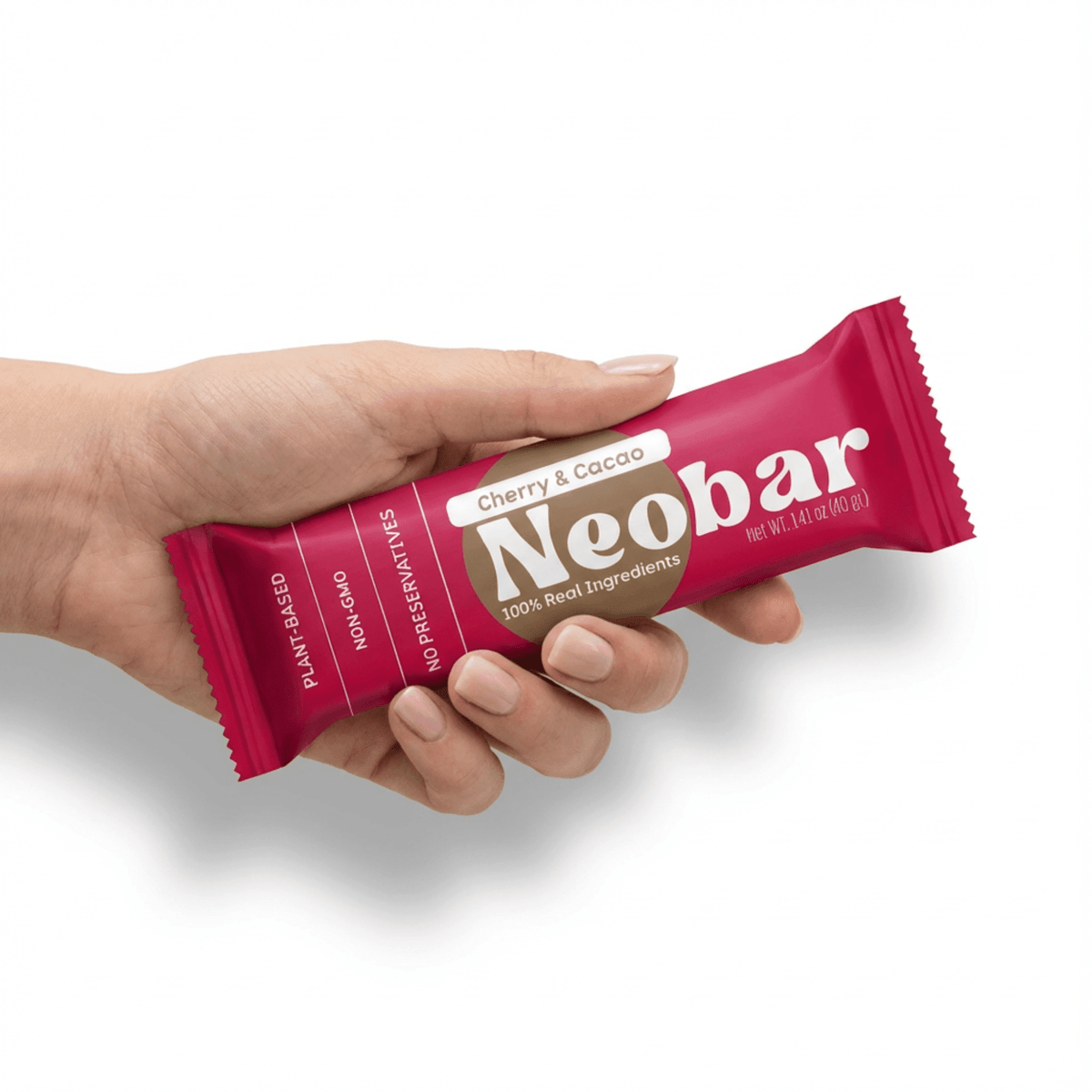 Hand holding a Neobar cherry and cacao bar against a white background