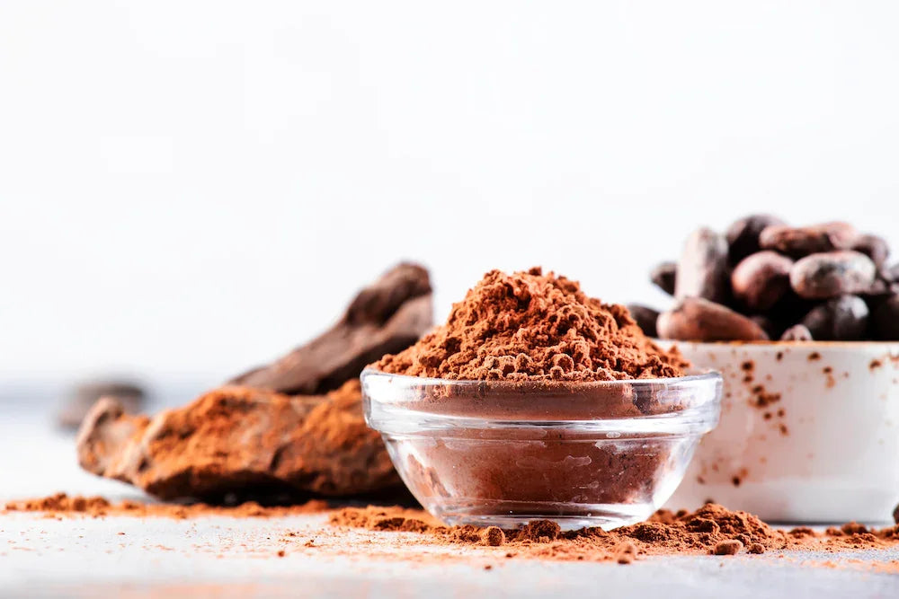 Organic cocoa powder and beans for Essential Candy Cacao Mint™ Botanical Lozenges, showcasing natural ingredients and holiday blend.
