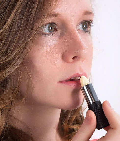 Red Apple Rallye Balm by Red Apple Lipstick, featuring a sleek red tube and the balm's smooth, glossy finish.