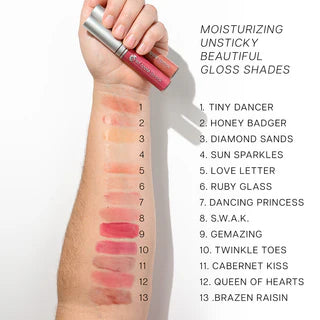 Red Apple Lipstick Red Apple Lip Gloss swatched on skin showing vibrant red color and glossy finish.