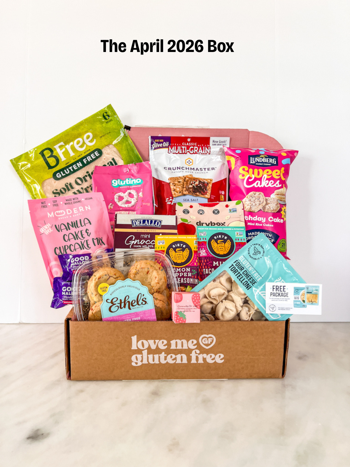 Love Me Gluten Free Signature Monthly GF Subscription Box for April 2026 with gluten-free snacks and treats inside.