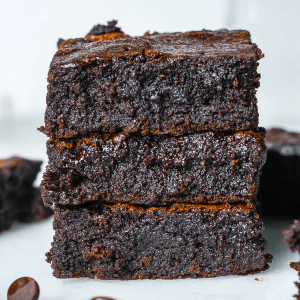 Gluten-free fudge brownies in Sweet Addison's Brownie Box, showing rich, chocolatey texture and fudgy appearance.