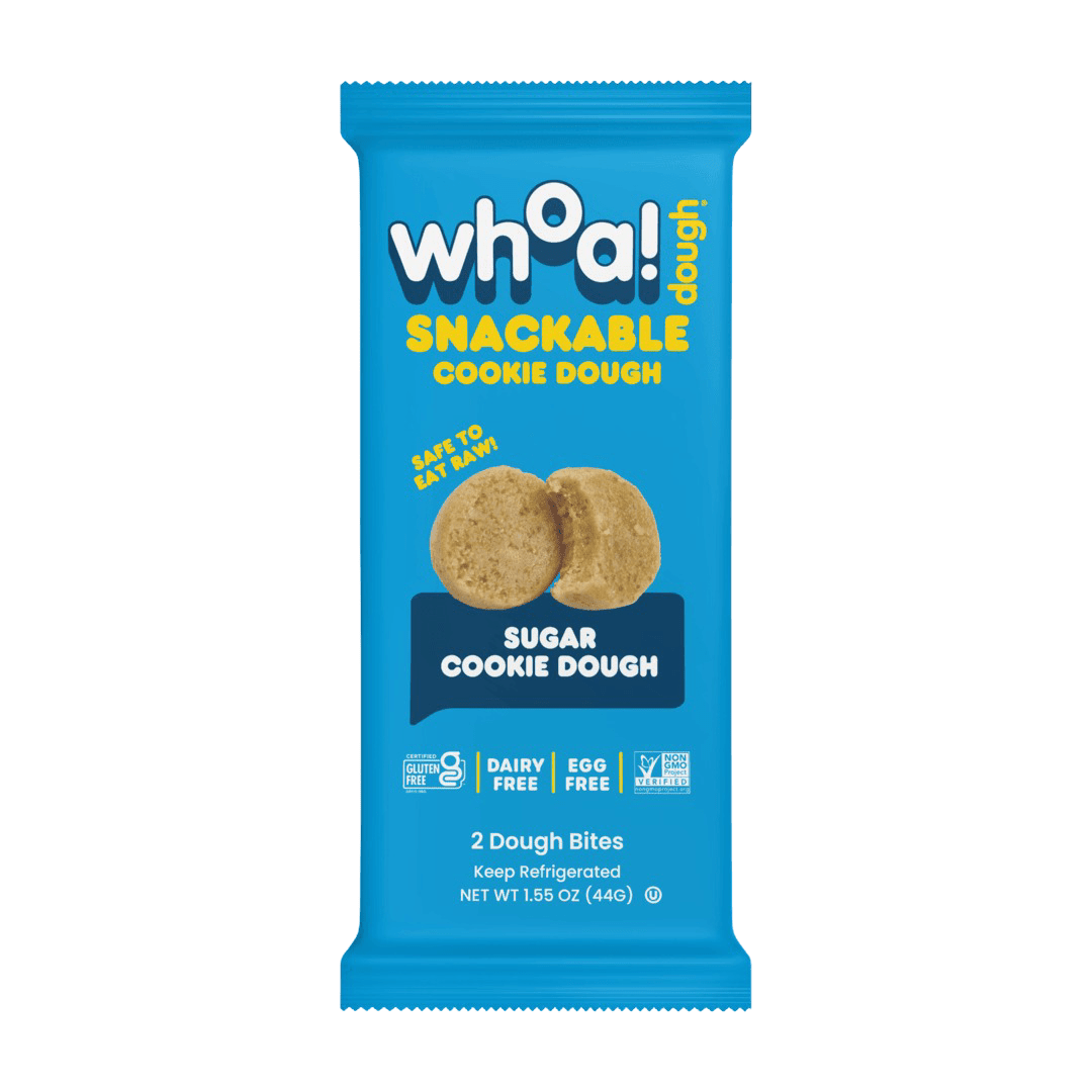 Snackable sugar cookie dough from Whoa! Dough, 14-pack, showing bite-sized cookie pieces in a clear container.