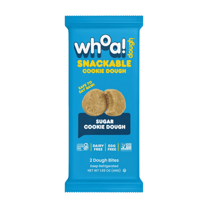 Snackable sugar cookie dough from Whoa! Dough, 14-pack, showing bite-sized cookie pieces in a clear container.