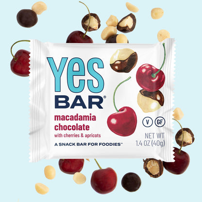 YES BAR Macadamia Chocolate snack bars, six-pack, showing clean-edged, chocolate-covered bars with visible macadamia nuts.